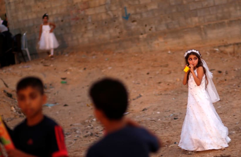 A Palestinian girl attends a mass wedding in Gaza, July 2016 (photo credit: MOHAMMED SALEM/ REUTERS)