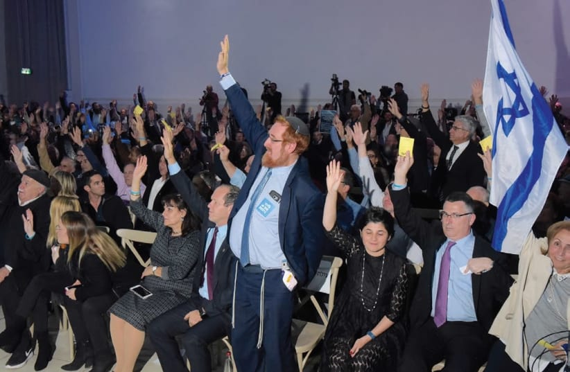 LIKUD CENTRAL COMMITTEE members vote to endorse exercising Israel’s sovereignty over Judea and Samaria last night at Airport City. (photo credit: AVSHALOM SHOSHANI)