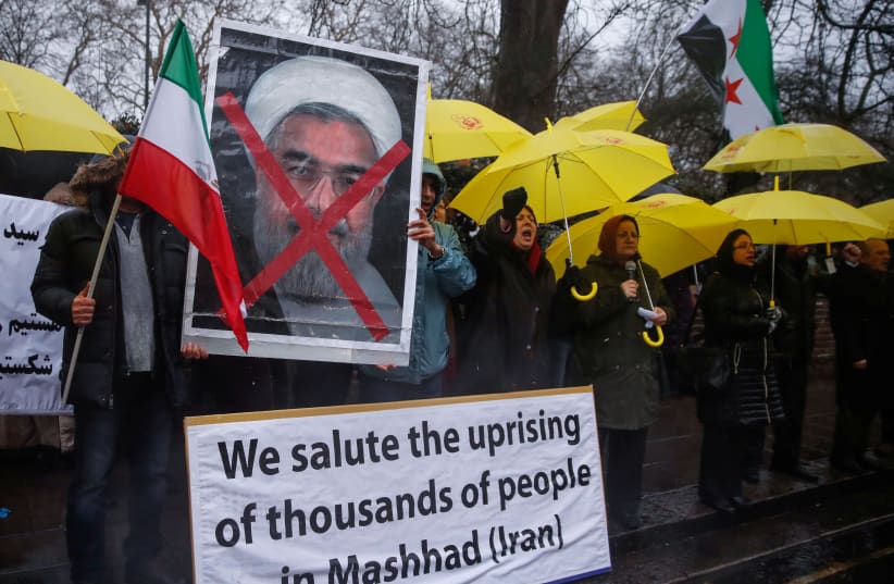 Opponents of Iranian President Hassan Rouhani hold a protest outside the Iranian embassy in west London. (photo credit: REUTERS)