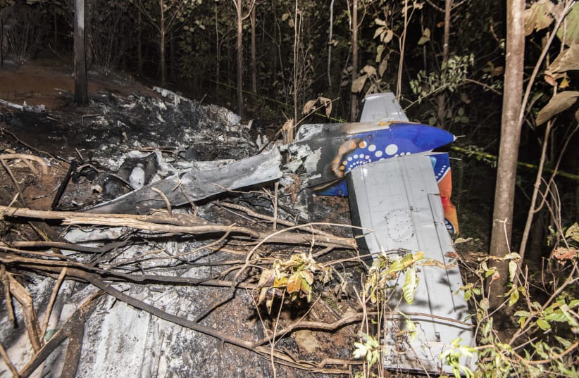 he tail of the burned fuselage of a small plane that crashed is seen in Guanacaste, Corozalito, Costa Rica on December 31, 2017 (photo credit: EZEQUIEL BECERRA / AFP)