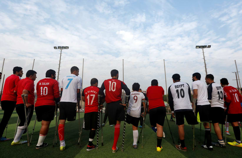 Members of "Miracle Team", a soccer team made up of one-legged soccer players, listen to their coach before a training session at El Salam club on the outskirts of Cairo (photo credit: AMR ABDALLAH DALSH / REUTERS)