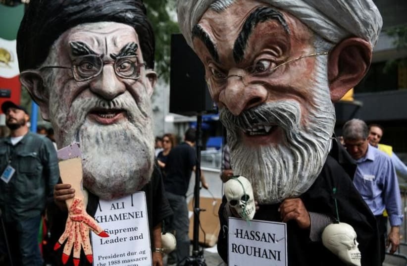 Iranian Americans and opponents of Iranian President Hassan Rouhani hold protests outside of UN headquarters on the day Rouhani addresses the General Assembly of the United Nations in New York, US, September 20, 2017. (File Photo) (photo credit: REUTERS/AMR ALFIKY)
