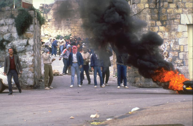 PALESTINIANS BURN tires in a demonstration during the First Intifada in Ramallah in 1988 (photo credit: GPO)