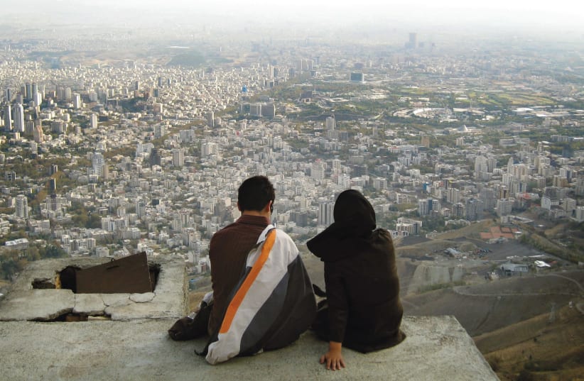 AN IRANIAN couple looks out over the city of Tehran. (photo credit: REUTERS)