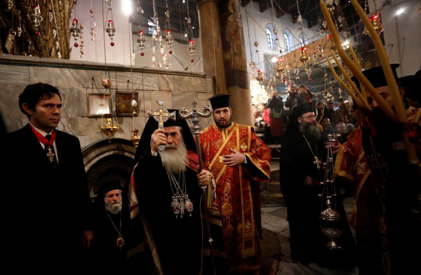 The Greek Orthodox Patriarch of Jerusalem Theophilos III attends a Christmas service according to the Eastern Orthodox calendar, in the church of Nativity in the West Bank city of Bethlehem. (photo credit: REUTERS)