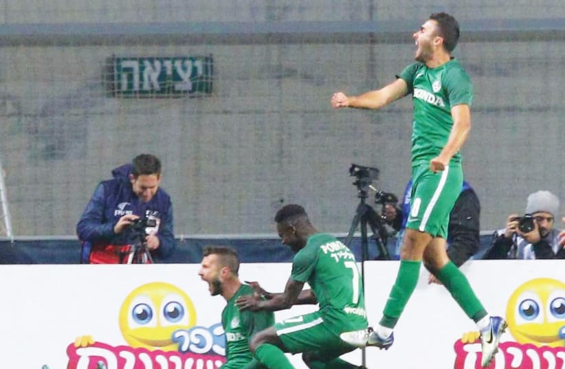 Maccabi Haifa players Nikita Rukavytsya (left), Sintiyahu Salalik (center) and Mohammed Awad celebrate during last night’s win over Hapoel Tel Aviv on penalties in the State Cup round-of-32. (photo credit: ADI AVISHAI)