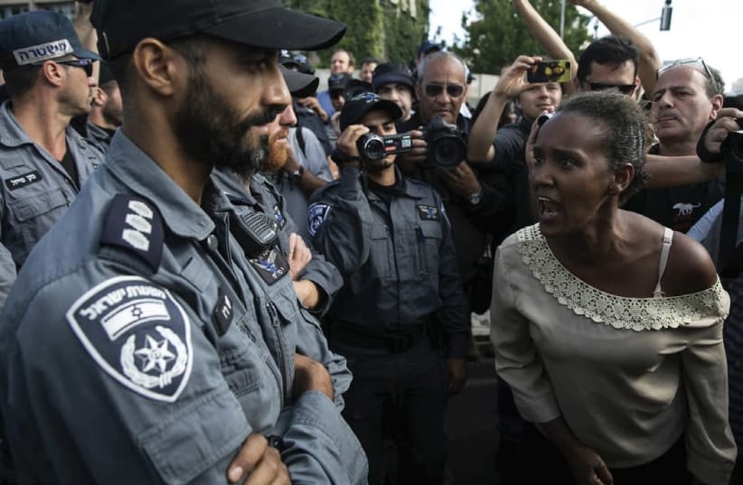 AN ETHIOPIAN PROTESTER shouts at a policeman during a demonstration in Tel Aviv against what protesters say is police racism and brutality. (photo credit: BAZ RATNER/REUTERS)