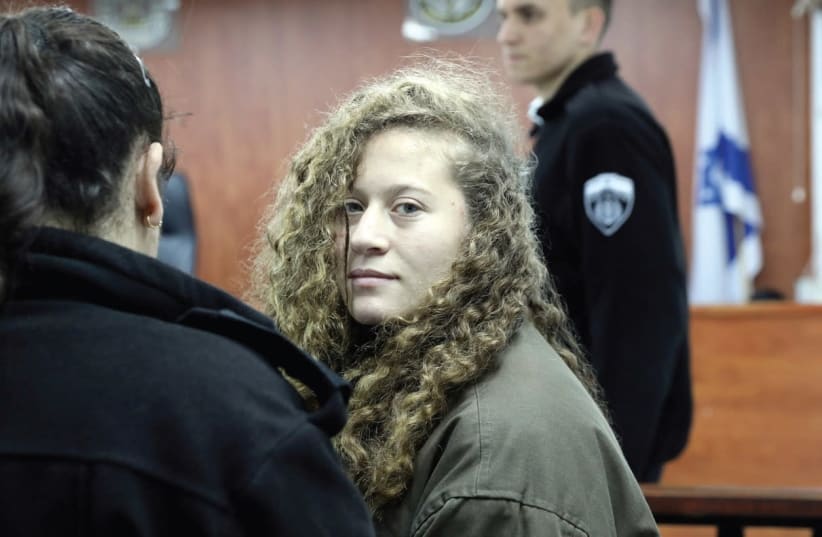 Ahed Tamimi (center) enters a military courtroom at Ofer Prison near Ramallah on New Year’s Day. (photo credit: AMMAR AWAD/REUTERS)