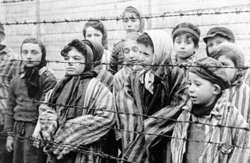 Young survivors of Auschwitz await the arrival of their Soviet liberators on January 7, 1945 (photo credit: Wikimedia Commons)