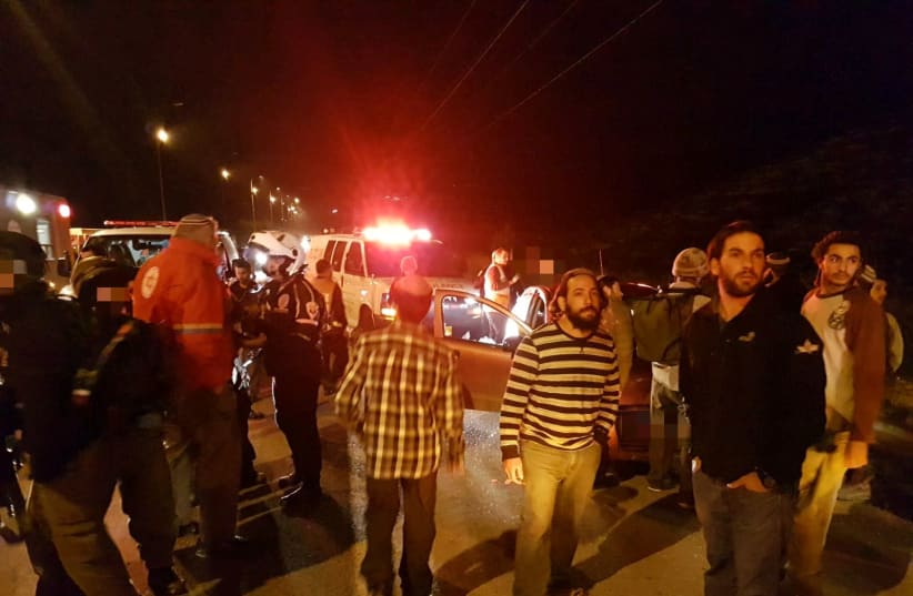 People standing around the scene of a shooting in the West Bank. (photo credit: COURTESY MDA)
