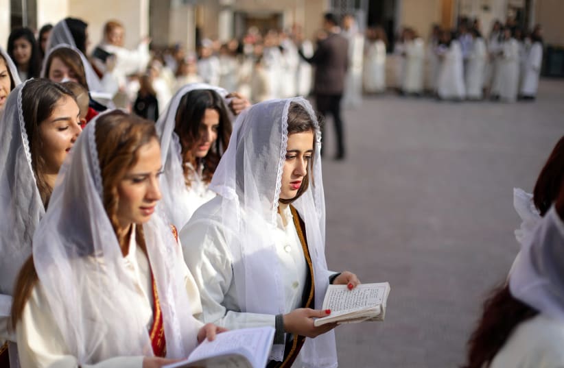 Syriac Christian women pray during mass at the Saint Efram Syriac Orthodox Church in Qamishly, Syria (photo credit: RODI SAID / REUTERS)