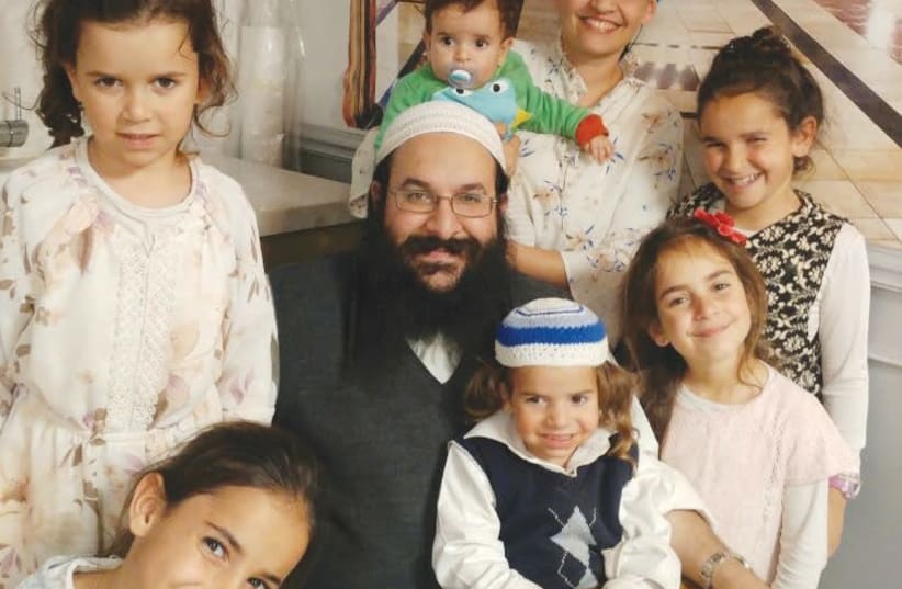 RAZIEL SHEVACH, whom a terrorist murdered on January 9th, 2018, is surrounded by his wife and six children in this recent photograph. (photo credit: Courtesy)