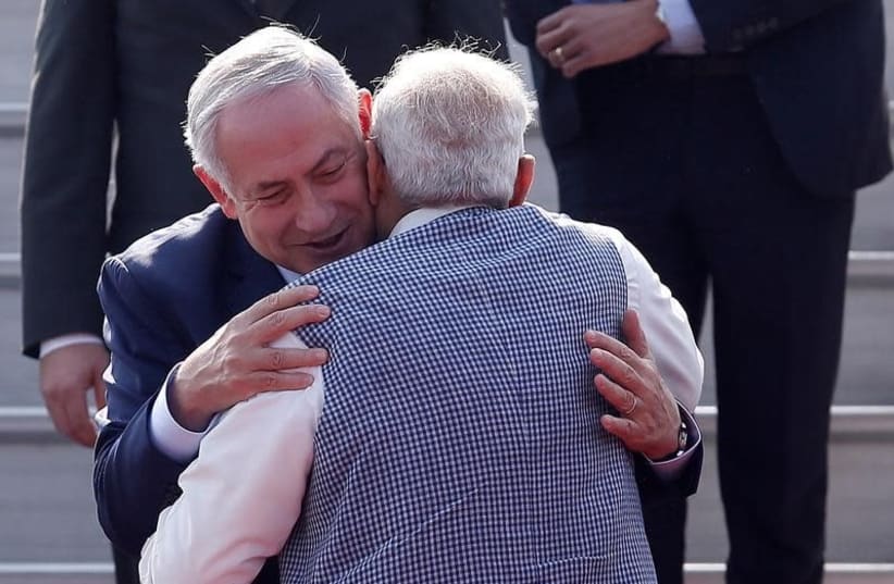 DATE IMPORTED: January 14, 2018 Israeli Prime Minister Benjamin Netanyahu and his Indian counterpart Narendra Modi hug each other upon Netanyahu's arrival at Air Force Station Palam in New Delhi, India, January 14, 2018. (photo credit: ADNAN ABIDI/ REUTERS)