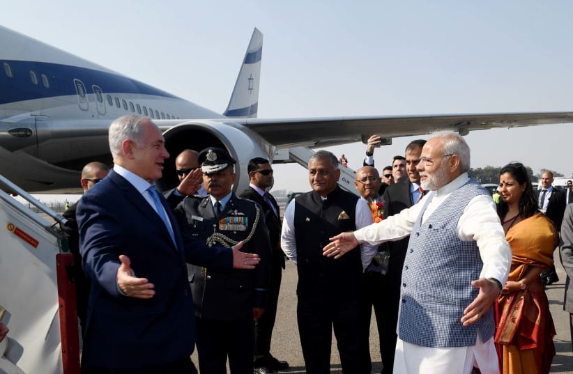 Prime Minister Benjamin Netanyahu is greeted with a hug by Indian Prime Minister Narendra Modi upon arrival in India, January 14, 2018  (photo credit: AVI OHAYON - GPO)