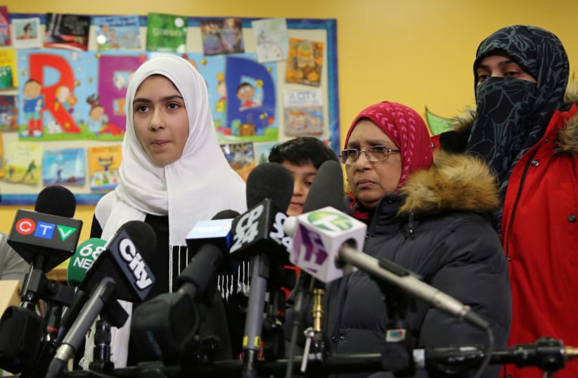 Khawlah Noman, 11, speaks to reporters with her mother at Pauline Johnson Junior Public School, after she told police that a man cut her hijab with scissors in Toronto, Ontario, Canada. (photo credit: REUTERS)