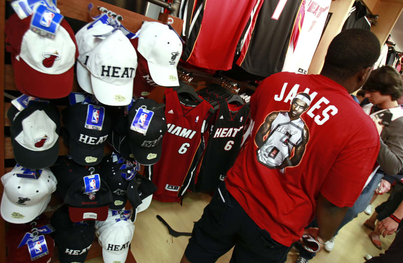 A basketball fan wearing a LeBron James T-shirt at the NBA store in Miami. (photo credit: REUTERS)