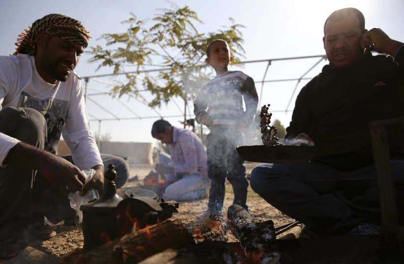 BEDUIN MEN roast coffee beans in a small village near the Beduin town of Rahat in the Negev in December 2015. (photo credit: AMIR COHEN/REUTERS)