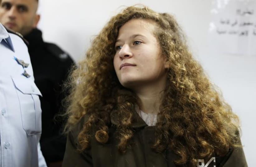 Palestinian teen Ahed Tamimi enters a military courtroom at Ofer Prison, near the West Bank city of Ramallah, January 15, 2018. REUTERS/Ammar Awad (photo credit: AMMAR AWAD/REUTERS)