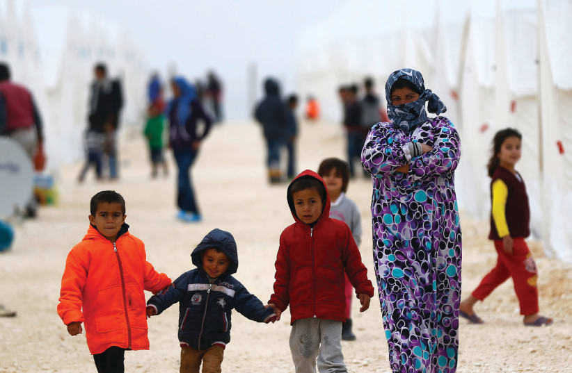 DISPLACED SYRIANS walk in a refugee camp in the Turkish border town of Suruc in January 2015 (photo credit: OSMAN ORSAL/REUTERS)