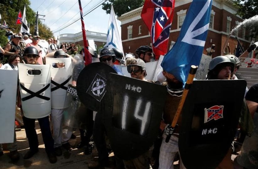 White supremacists stand behind their shields at a rally in Charlottesville, Virginia, US, August 12, 2017 (photo credit: REUTERS/JOSHUA ROBERTS)