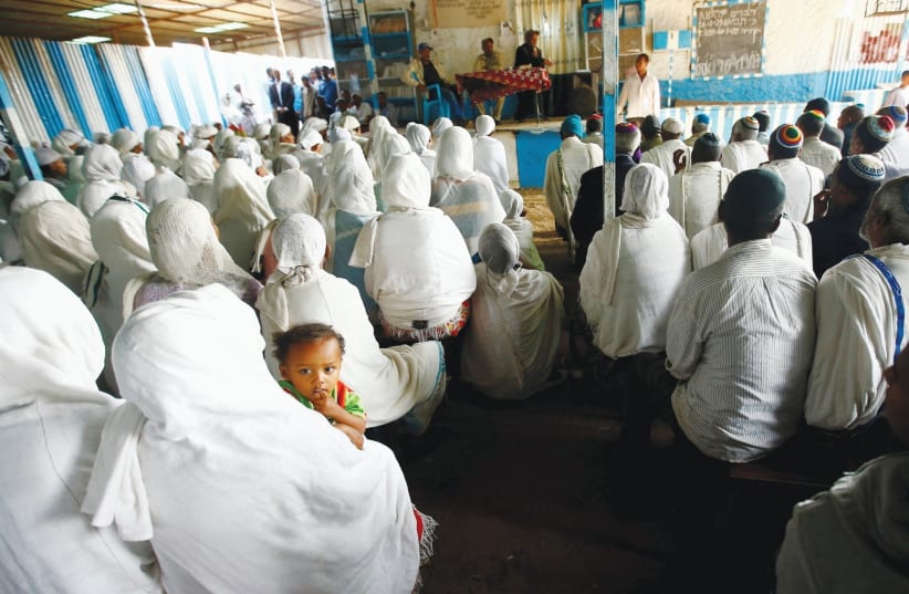 MEMBERS OF the Falash Mura Jewish Ethiopian community attend a prayer service at the HaTikvah Synagogue in Gondar, northern Ethiopia, in 2016.  (photo credit: TIKSA NEGERI / REUTERS)