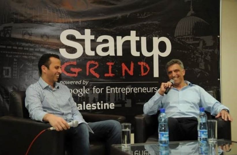 Israeli venture capitalist Yadin Kaufmann, a major investor in Palestinian startups, sits down with Palestinian entrepreneur Peter Abualzolof at a conference in Ramallah in 2014.  (photo credit: Courtesy)