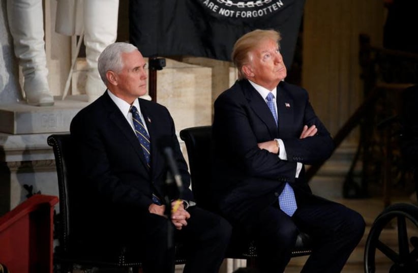 US President Donald Trump looks at the Capitol Rotunda as he sits with US Vice President Mike Pence during a Congressional Gold Medal ceremony honoring former Senate majority leader Bob Dole on Wednesday. (photo credit: REUTERS)