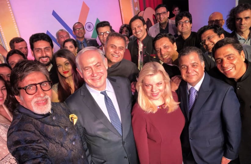 Benjamin Netanyahu and wife Sara taking a selfie with noted Indian actors during a state visit in India  (photo credit: AVI OHAYON - GPO)