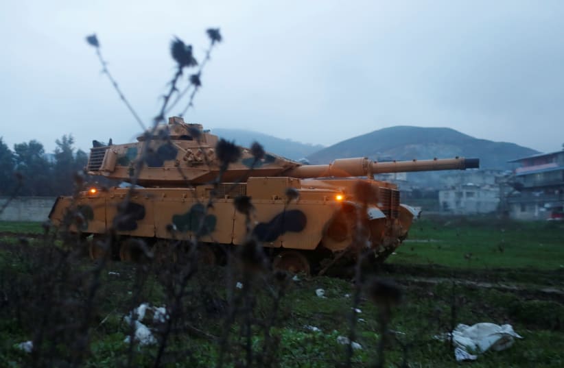 A Turkish military tank arrives at an army base in the border town of Reyhanli near the Turkish-Syrian border in Hatay province, Turkey. (photo credit: REUTERS)