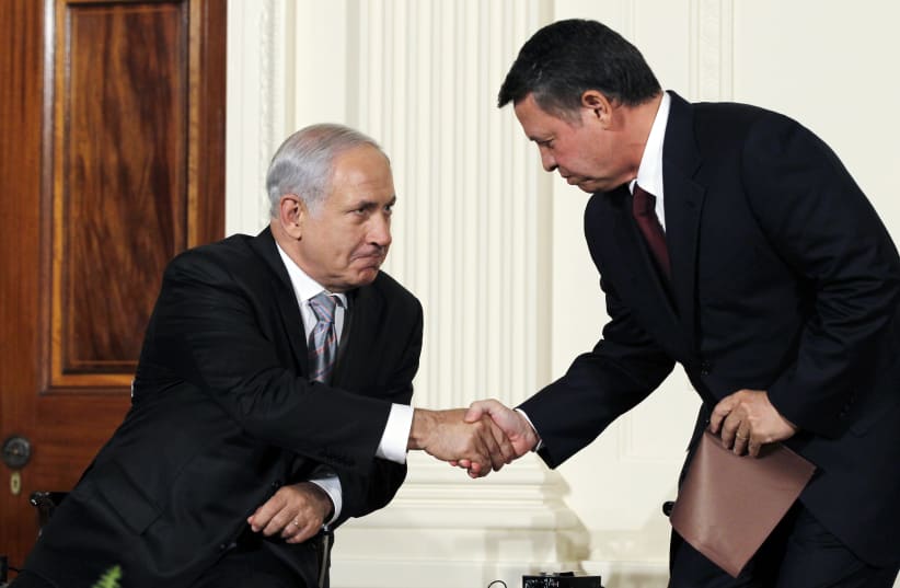 File: Jordan's King Abdullah II greets Israeli Prime Minister Netanyahu at the White House in Washington (photo credit: REUTERS/JASON REED)