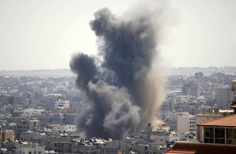 Smoke rises following what witnesses said was an Israeli air strike in Gaza August 21, 2014. (photo credit: AHMED ZAKOT / REUTERS)