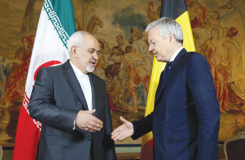 BELGIAN FOREIGN MINISTER Didier Reynders (right) welcomes his Iranian counterpart, Muhammad Javad Zarif, at Egmont Palace in Brussels in January 2018. (photo credit: REUTERS/FRANCOIS LENOIR)