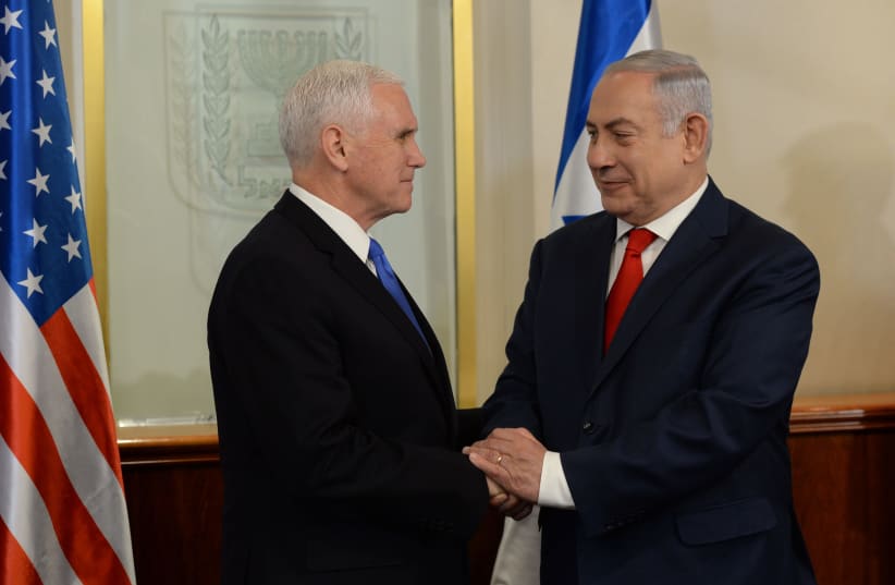 Prime Minister Benjamin Netanyahu shakes hands with Vice President of the United States Mike Pence (photo credit: CHAIM TZACH/GPO)