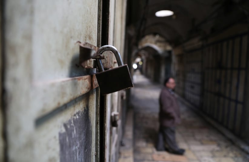 A lock is seen on a closed shop in the Old City of Jerusalem as part of the general Palestinan strike against US VP Pence's visit, January 2018 (photo credit: AMMAR AWAD / REUTERS)
