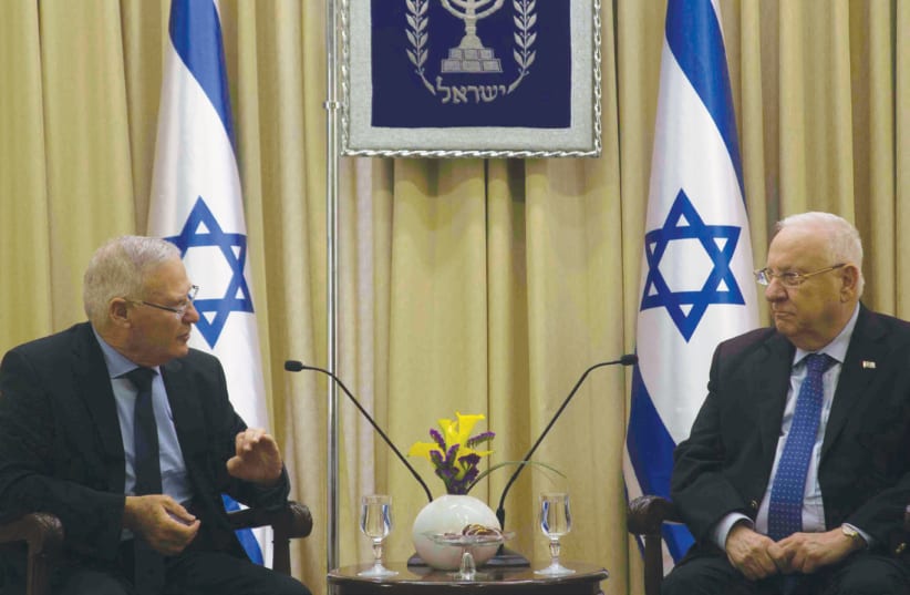 Amos Yadlin discusses the latest INSS Strategy Assessment with President Reuven Rivlin on January 1 (photo credit: SARAH LEVI)