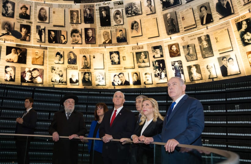 US Vice President Mike Pence and wife Karen listen to a guide with the Netanyahus as they visit the Yad Vashem Holocaust History Museum in Jerusalem (photo credit: ALEX KOLOMOISKY / POOL)