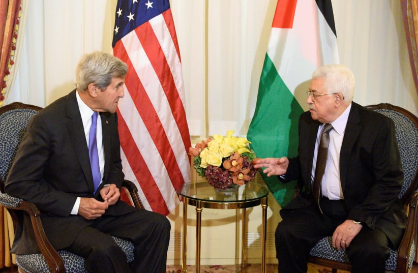 Then-U.S. Secretary of State John Kerry speaks with Palestinian Authority President Mahmoud Abbas during a bilateral meeting at the Waldorf Astoria in Manhattan on September 19, 2016.  (photo credit: REUTERS/DARREN ORNITZ)