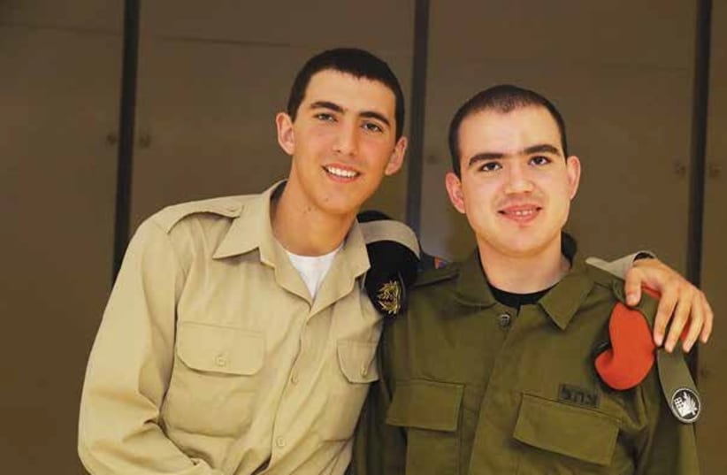 Ilay (right) poses with his brother Adam during his IDF swearing in ceremony last year.  (photo credit: Courtesy)