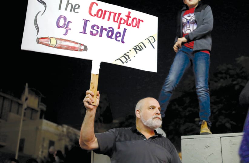 ISRAELIS TAKE PART in a protest against corruption in Tel Aviv last year (photo credit: AMIR COHEN/REUTERS)