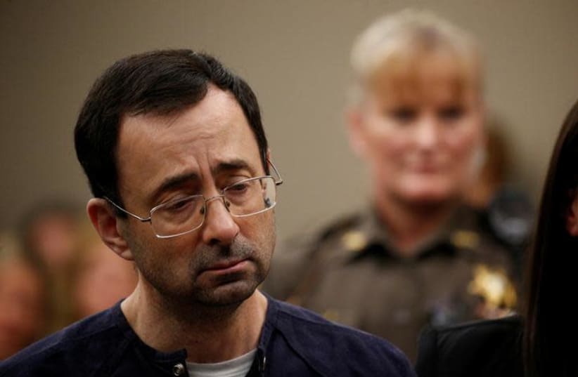 Larry Nassar, a former team USA Gymnastics doctor who pleaded guilty in November 2017 to sexual assault charges, stands during his sentencing hearing in Lansing, Michigan, US, January 24, 2018.  (photo credit: BRENDAN MCDERMID/REUTERS)