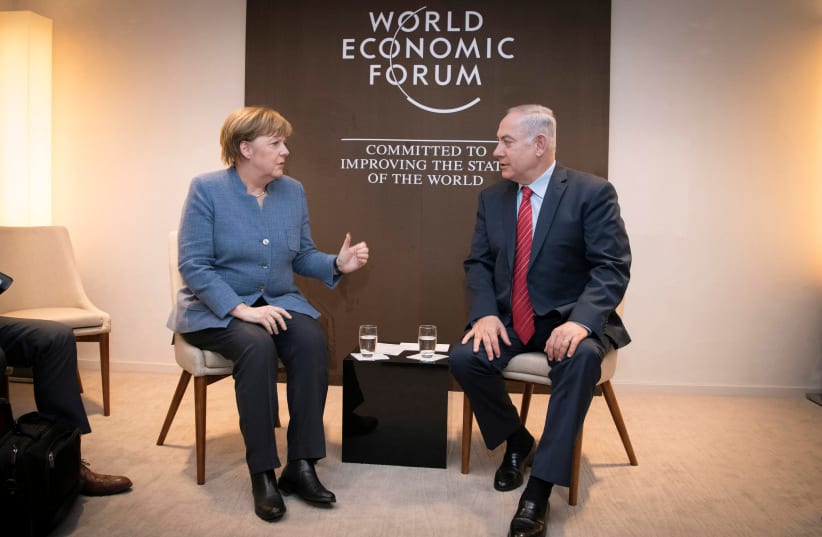 German Chancellor Angela Merkel meets Israeli Prime Minister Benjamin Netanyahu during the World Economic Forum (WEF) annual meeting in Davos, Switzerland January 24, 2018. (photo credit: BUNDESREGIERUNG/GUIDO BERGMANN/HANDOUT VIA REUTER)