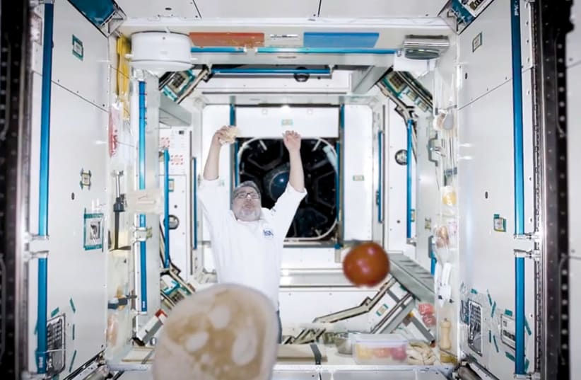 CHEF HAIM COHEN tries to make a falafel in a reenactment of space for the Science and Technology Ministry’s Space Week activities, which are launched on January 28, 2018.. (photo credit: screenshot)
