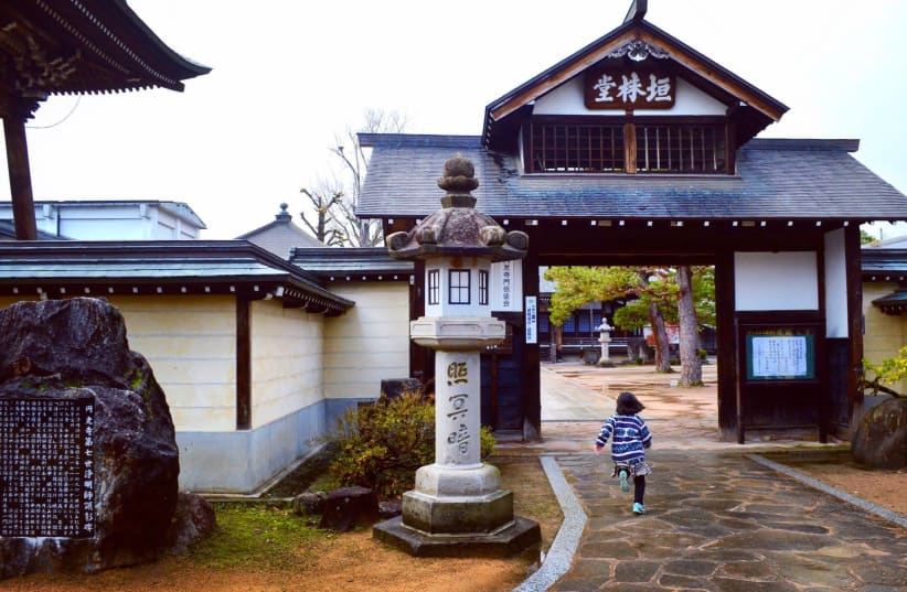 A girl runs toward a shrine in Hida Furukawa, in Japan's Gifu prefecture, where the local government is promoting Chiune Sugihara's legacy as a tourism draw. (Michael Wilner, November 2017) (photo credit: MICHAEL WILNER)