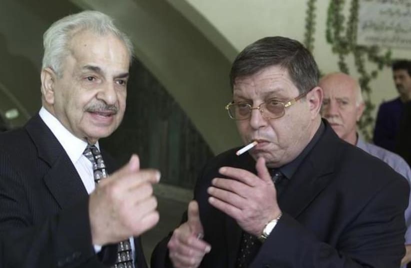 Ghassan al-Shakaa (R) member of the Palestinian Liberation Organisation (PLO) talks to Mahmoud al-Khalidi, then Palestinian ambassador to Syria on September 25, 2001. (REUTERS / Khaled al-Hariri) (photo credit: REUTERS/KHALED AL-HARIRI)
