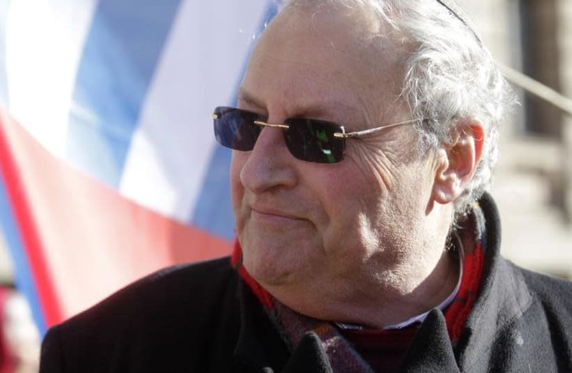 Simon Wiesenthal Center Director Efraim Zuroff attends a protest against the annual procession commemorating the Latvian Waffen-SS (Schutzstaffel) unit, also known as the Legionnaires, in Riga March 16, 2014. (REUTERS/Ints Kalnins) (photo credit: REUTERS/INTS KALNINS)