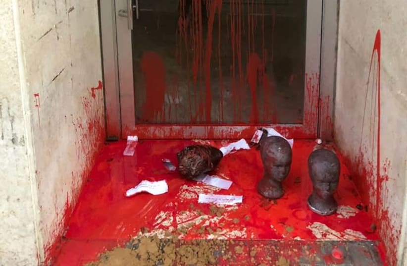 Severed heads and red paint are found outside the entrance the Ministry of Economy office in Tel Aviv, January 2018 (photo credit: POLICE SPOKESPERSON'S UNIT)