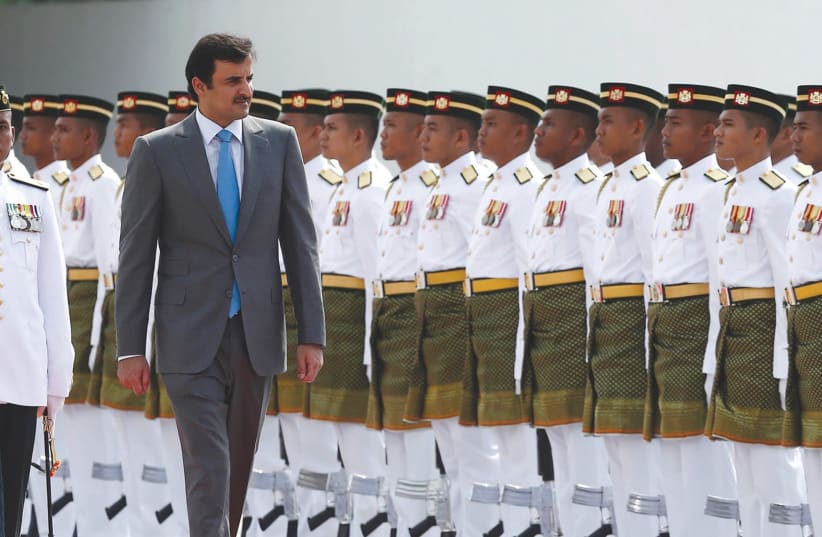 EMIR Sheikh Tamim bin Hamad al-Thani inspects an honor guard during a state welcome ceremony at the Parliament House in Kuala Lumpur, Malaysia. (photo credit: REUTERS)