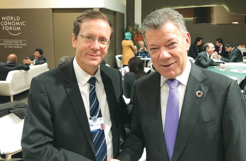 OPPOSITION LEADER Isaac Herzog with Colombian President Juan Manuel Santos in Davos. (photo credit: Courtesy)