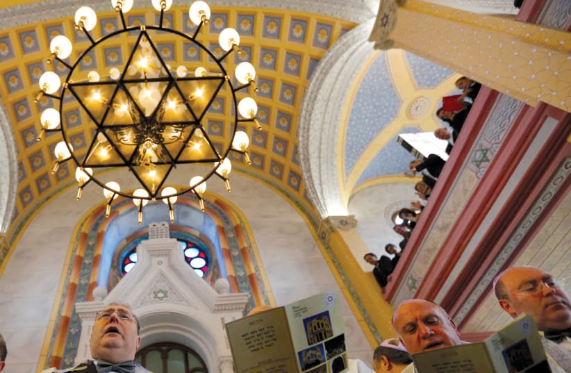 Jewish community members attend the re-opening ceremony of Great Synagogue in Edirne, western Turkey March 26, 2015. A five-year, $2.5 million government project has restored the Great Synagogue in the border city of Edirne, the first temple to open in Turkey in two generations. REUTERS/Murad Sezer (photo credit: MURAD SEZER/REUTERS)