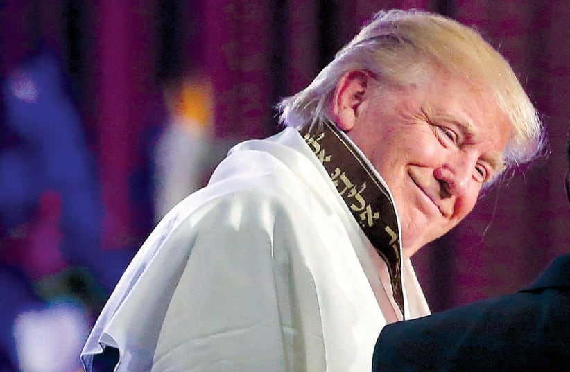 Donald Trump wears a tallit during a church service with Bishop Wayne T. Jackson at the Great Faith Ministries International in downtown Detroit (photo credit: CARLO ALLEGRI/REUTERS)